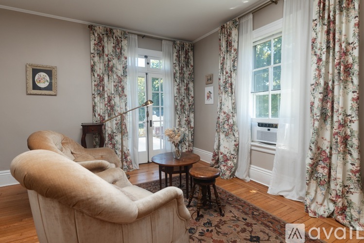 A living room with a large chair and a small table.