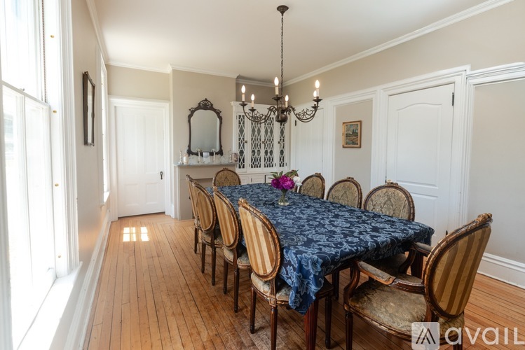 A dining room with a table set for six.