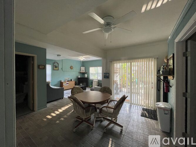 A dining room with a table and chairs.