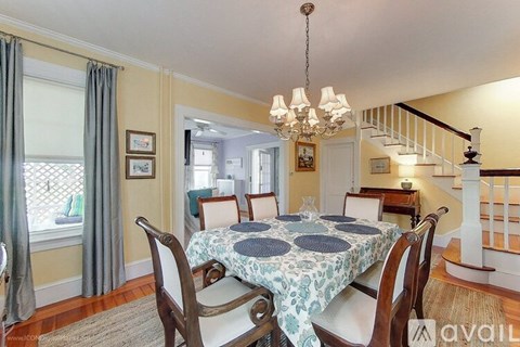 A dining room with a table set for six.