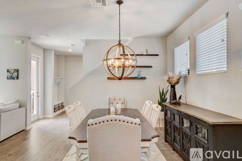 A modern dining room with a wooden table and chairs.