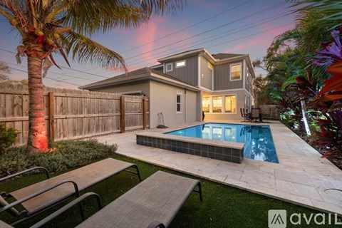 A modern house with a pool in the backyard.