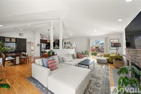 A living room with a white couch and a coffee table.