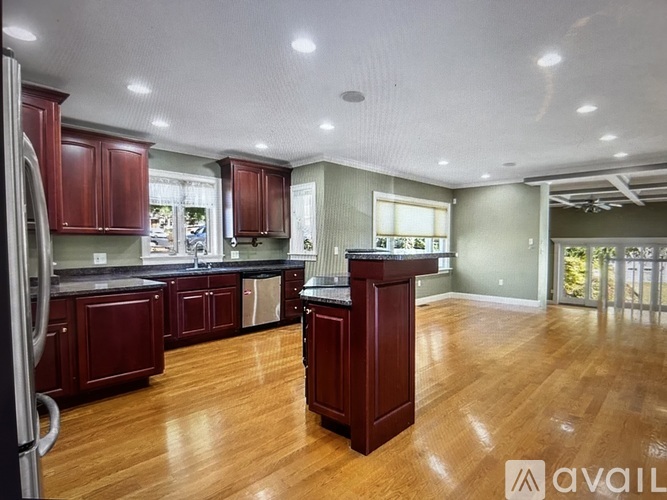 A kitchen with dark wood cabinets and a central island.