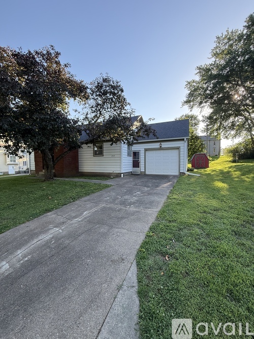 A house with a driveway and a garage is shown in the image.