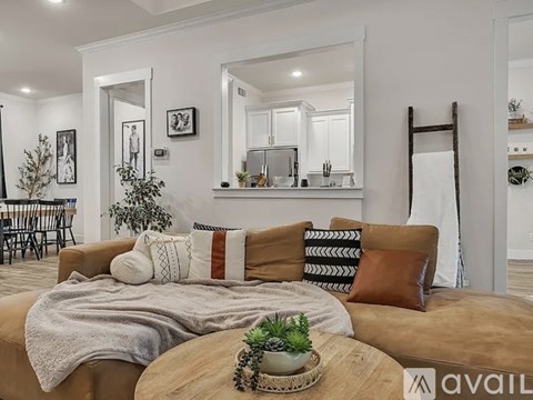A living room with a brown couch and a wooden coffee table.