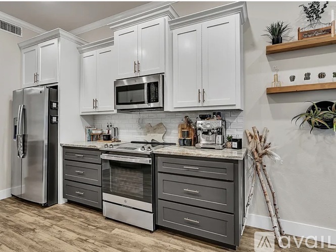 A kitchen with white cabinets and stainless steel appliances.