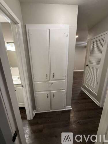 A white double wardrobe with two doors and two drawers is in a room with wooden floors.
