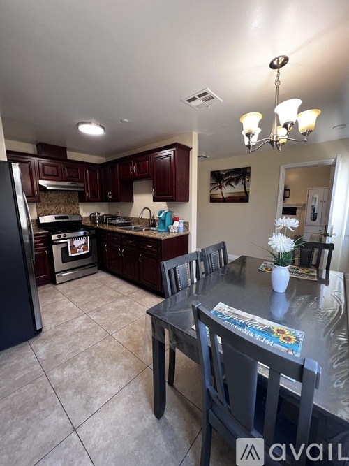 A kitchen with a black table and chairs.