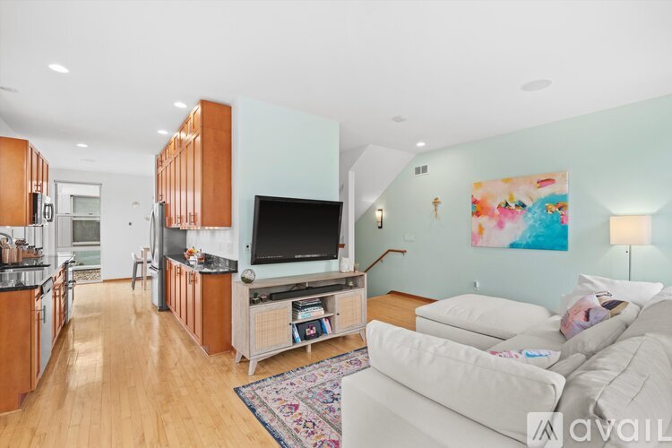 A living room with a white couch and a television.
