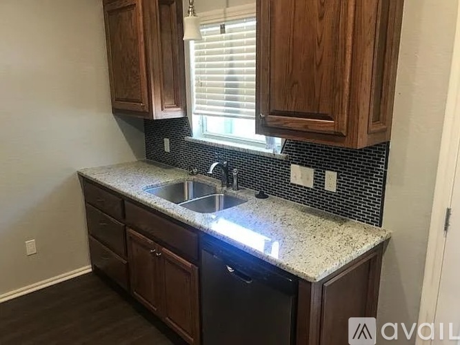 A kitchen with a sink and cabinets.