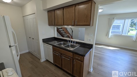 A kitchen with wooden cabinets and a black countertop.