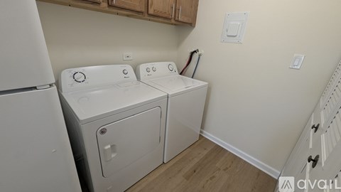 A white washing machine and dryer in a small laundry room.