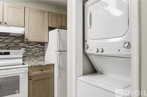 A white oven is in a kitchen with a white fridge.