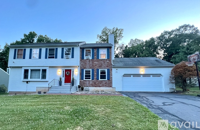 A two-story house with a red door and a garage.