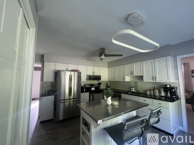 A kitchen with a refrigerator, stove, and oven.