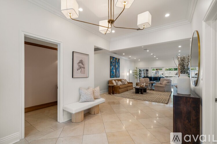 A well-lit, spacious living room with a variety of furniture and decor.