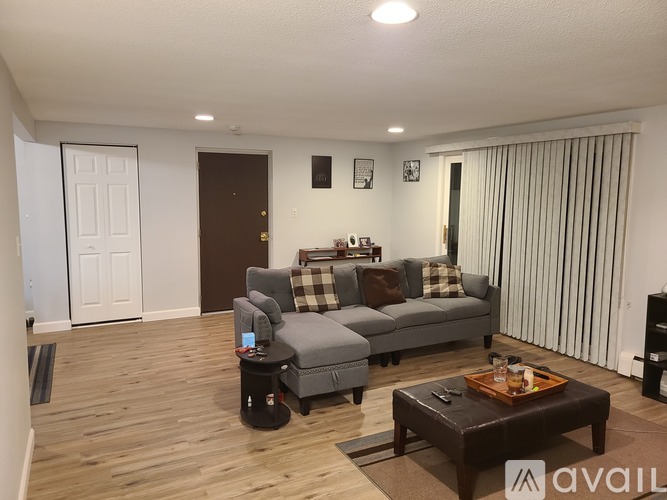 A living room with a grey couch and a coffee table.