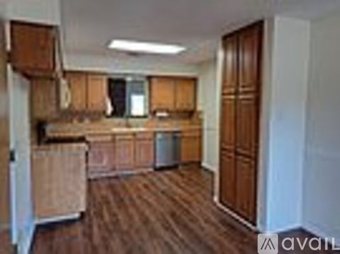 A kitchen with wooden cabinets and a countertop.