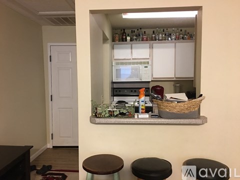 A kitchen area with a counter and a microwave.