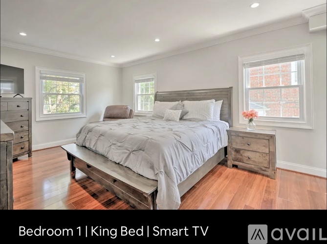 A bedroom with a king bed and a smart TV.