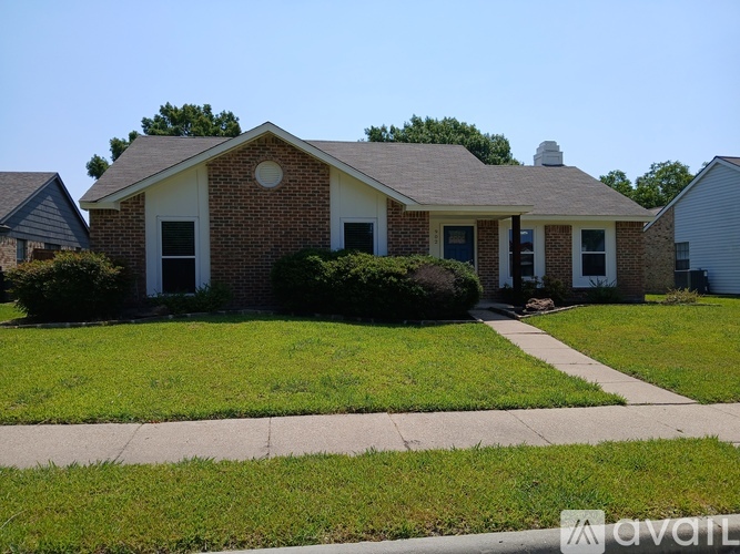 A house with a brick facade and a white door is for sale.