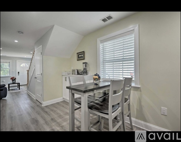A dining room with a glass table and chairs.