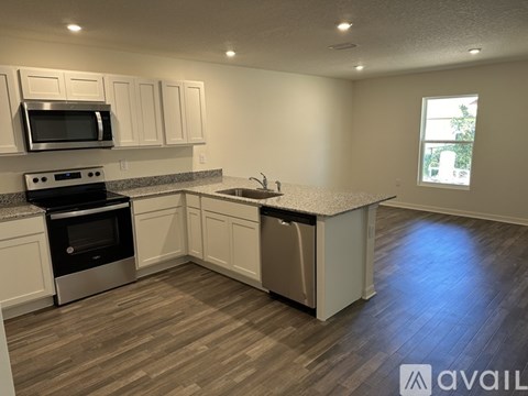 A kitchen with a stove top oven and microwave.