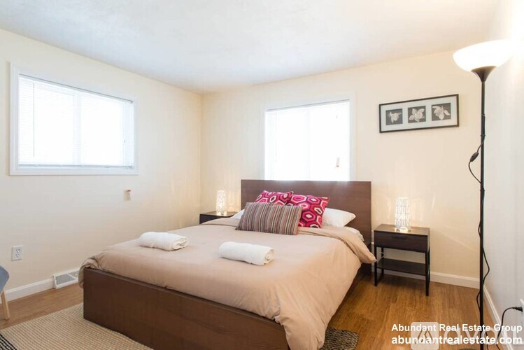 A bedroom with a large bed and a window.
