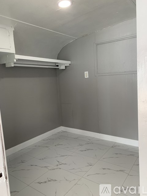 A room with grey walls and a marble floor.