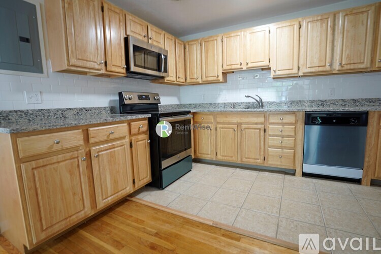 A kitchen with wooden cabinets and a black oven.