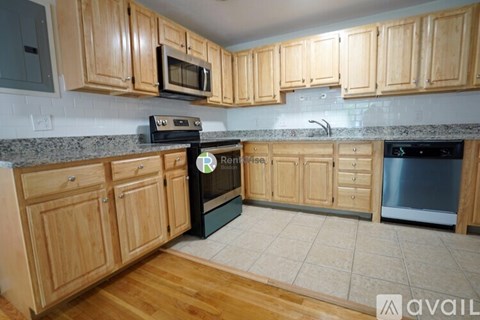 A kitchen with wooden cabinets and a black oven.