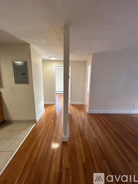 A room with wooden floors and white walls.
