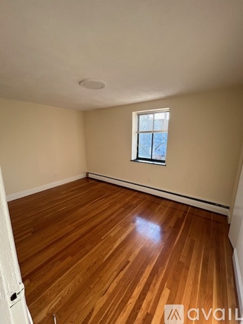 A room with wooden floors and a window.