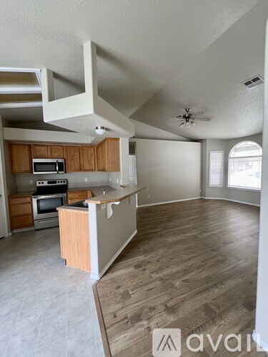 A kitchen with wooden cabinets and a white island.