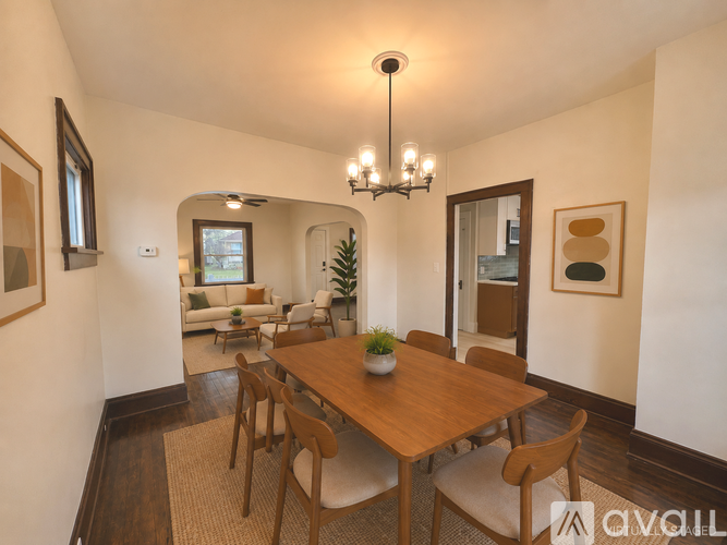 A dining room with a wooden table and chairs.