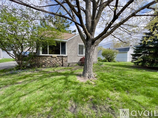 A house with a tree in front of it.