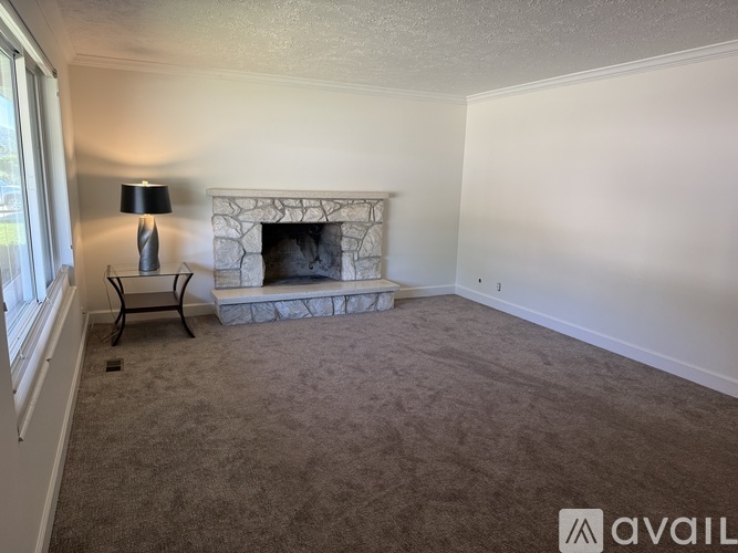 A living room with a fireplace and a chair.