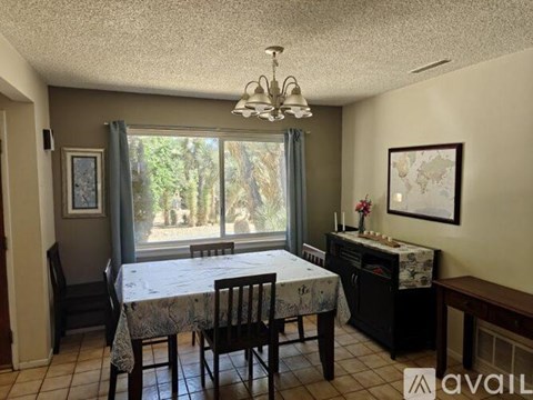 A dining room with a table set for four.