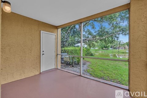 A kitchen with a refrigerator and a door open to a pantry.