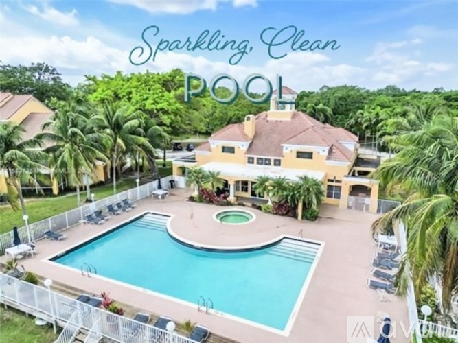 A house with a pool surrounded by palm trees and a sign that says "Relax by the pool, soak in the lakefront beauty!".