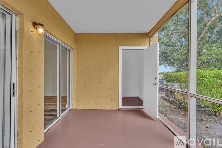 A spacious room with wood flooring and a ceiling fan.