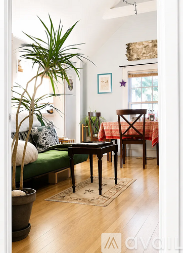 A living room with a green couch and a wooden table.