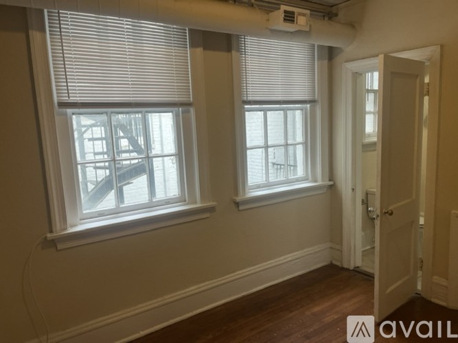 A room with two windows and a door.