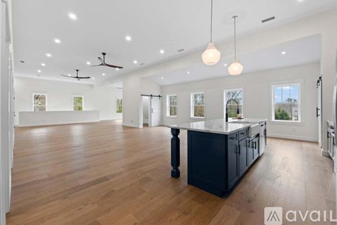 A spacious kitchen with dark wood cabinets and a central island.