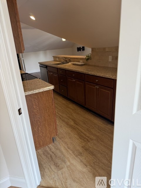 A kitchen with wooden cabinets and a countertop.