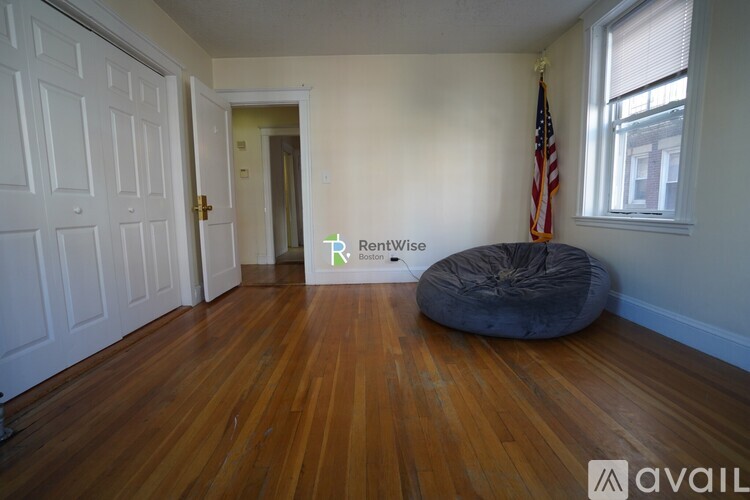 A room with wooden floors and a bean bag chair.