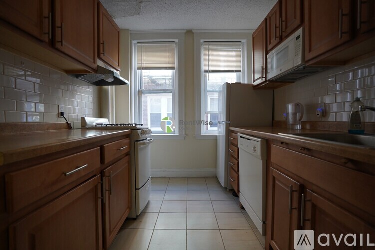 A kitchen with wooden cabinets and white appliances.