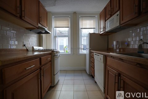 A kitchen with wooden cabinets and white appliances.