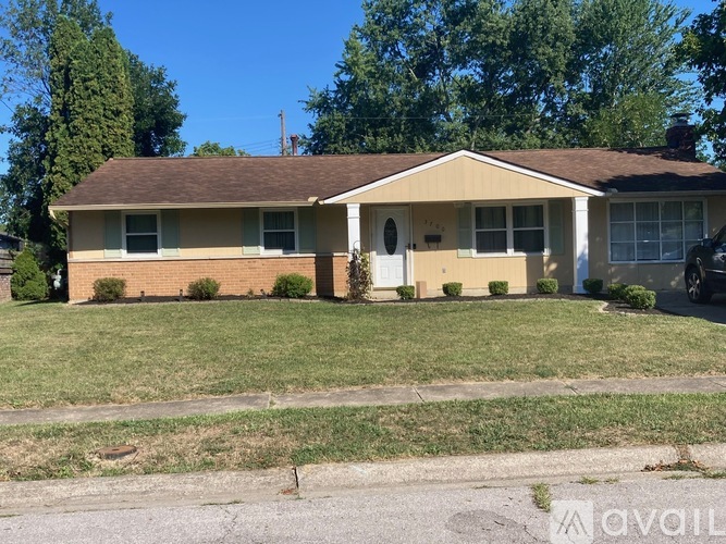 A house with a brown roof and a white door is for sale.